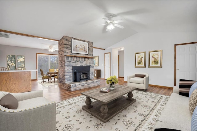 living room featuring vaulted ceiling, ceiling fan, and light hardwood / wood-style floors