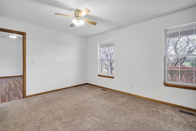 spare room with carpet and ceiling fan