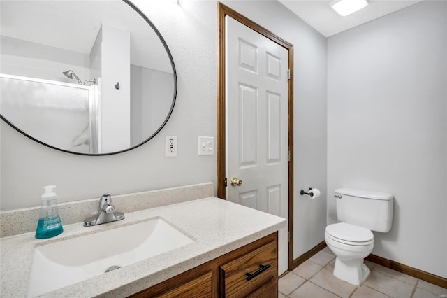 bathroom featuring vanity, tile patterned flooring, toilet, and a shower