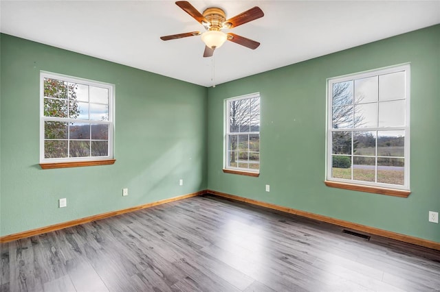 spare room with hardwood / wood-style flooring and ceiling fan