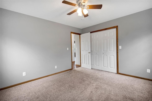 unfurnished bedroom featuring ceiling fan, carpet flooring, and a closet