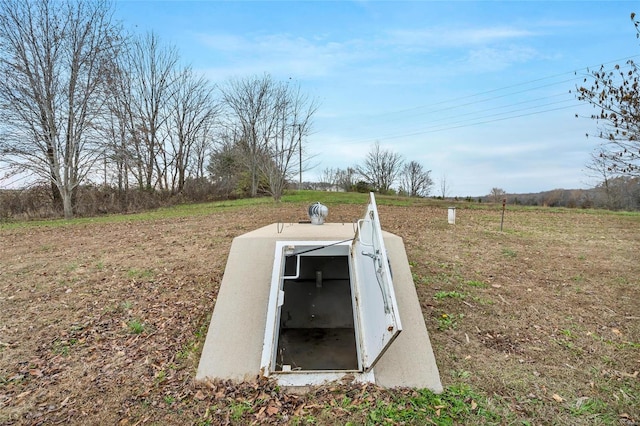 view of storm shelter featuring a rural view