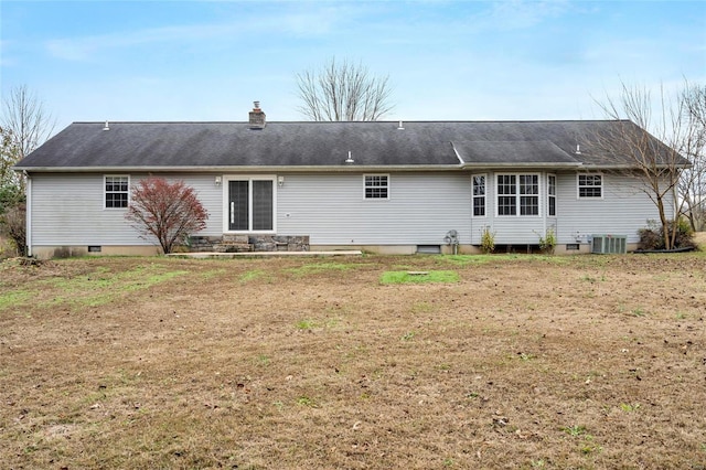 back of property with a yard and central air condition unit