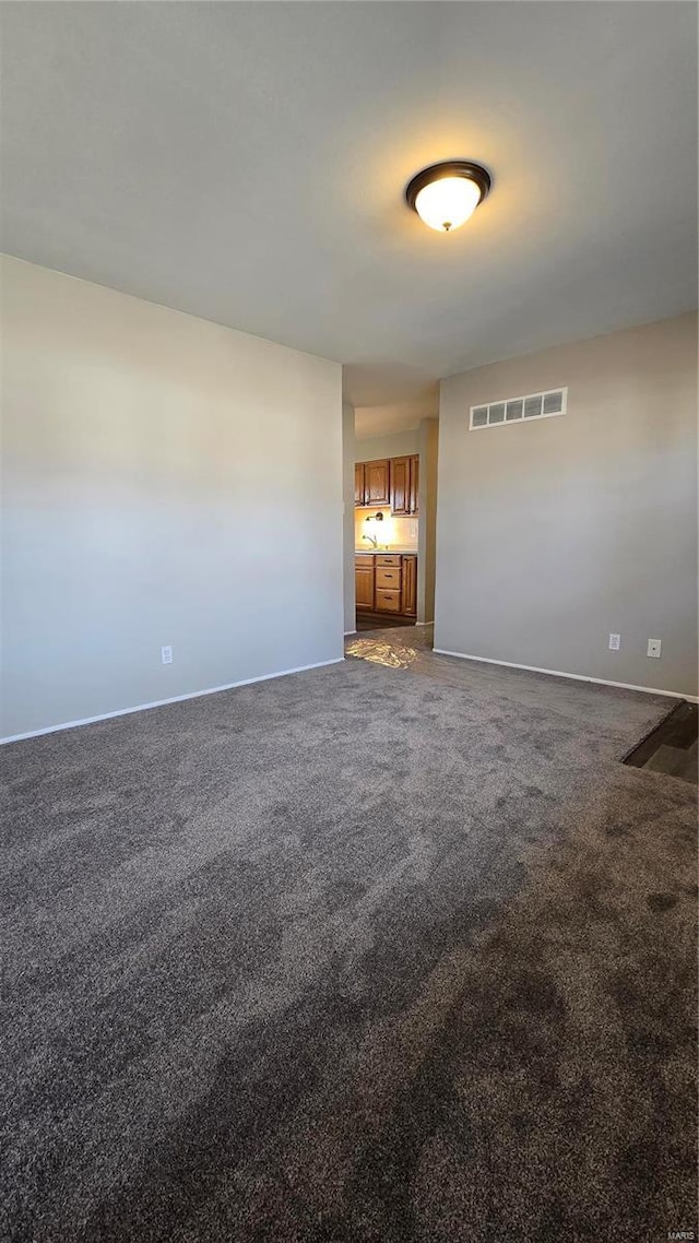 unfurnished living room featuring carpet