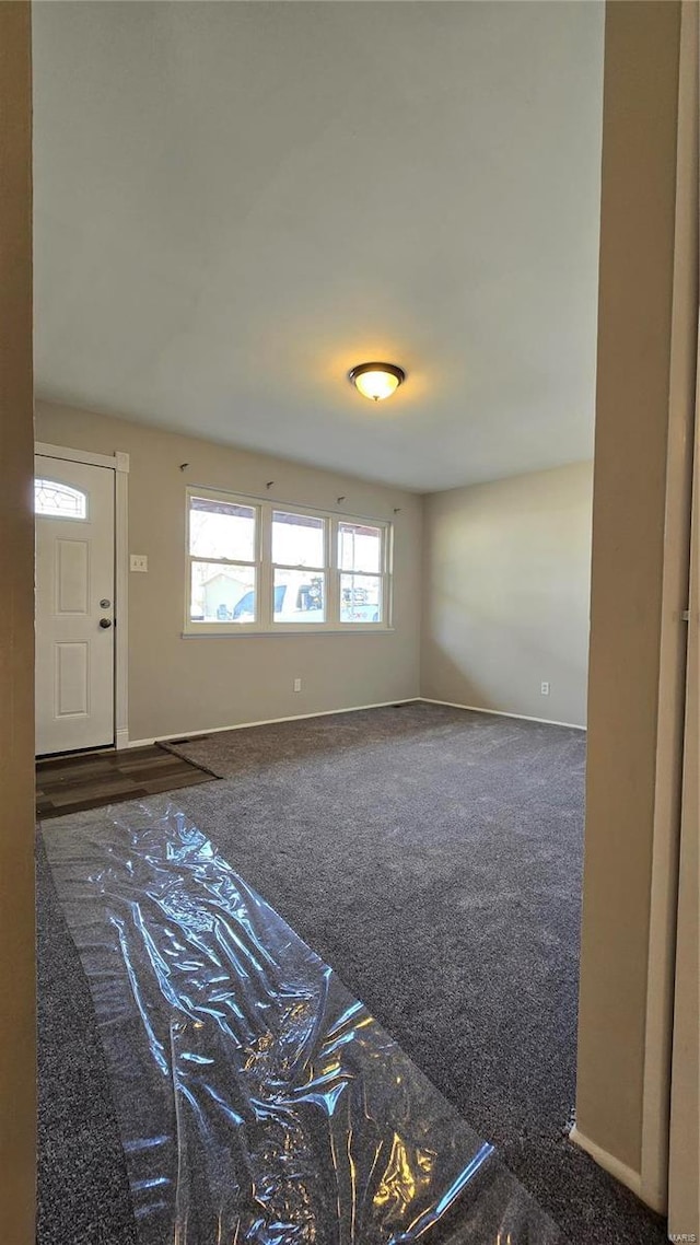 interior space featuring dark carpet