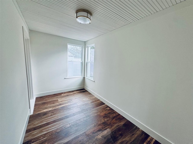 spare room with dark wood-type flooring