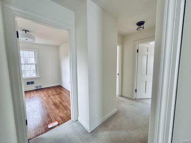 corridor with light colored carpet