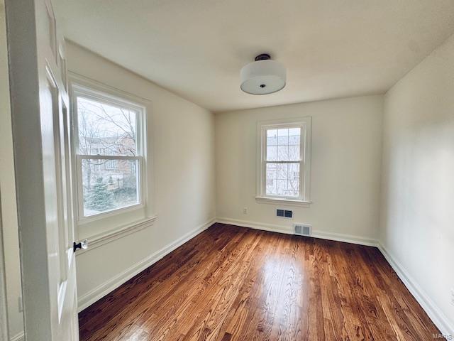 unfurnished room featuring dark hardwood / wood-style flooring