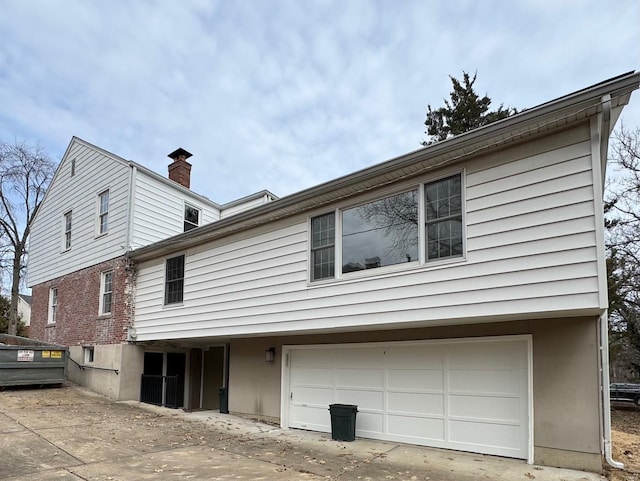 rear view of house featuring a garage