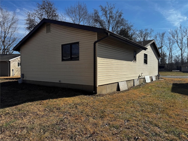 view of side of home featuring a lawn