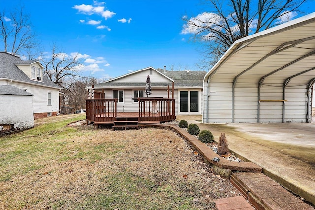 back of house featuring a wooden deck, a carport, and a lawn