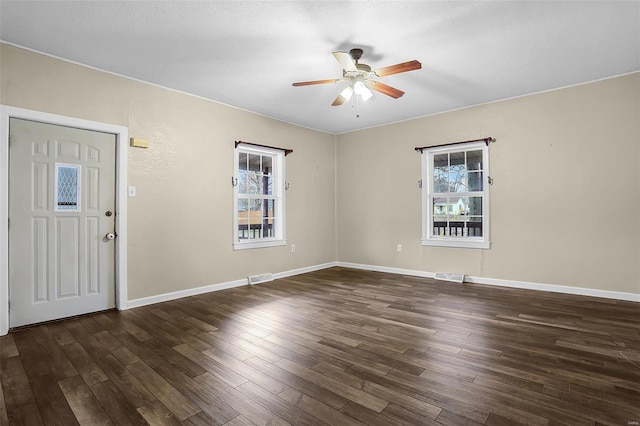 entryway with ceiling fan, a healthy amount of sunlight, and dark hardwood / wood-style flooring