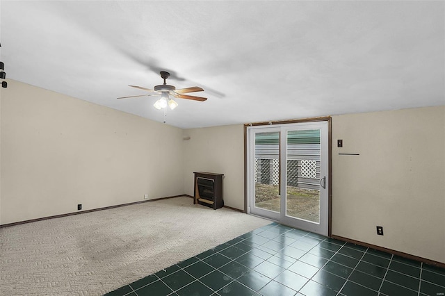 unfurnished living room with ceiling fan and dark colored carpet