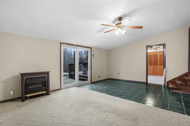 unfurnished living room featuring dark tile patterned floors, lofted ceiling, and ceiling fan