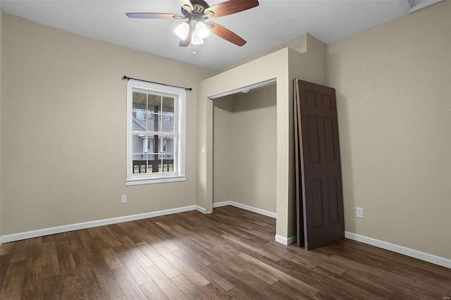 unfurnished bedroom featuring dark wood-type flooring and ceiling fan