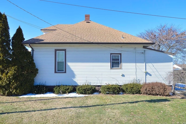 view of property exterior with a yard