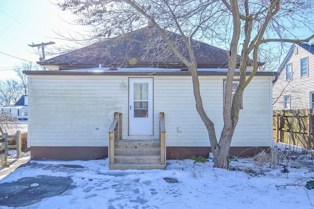 view of snow covered back of property