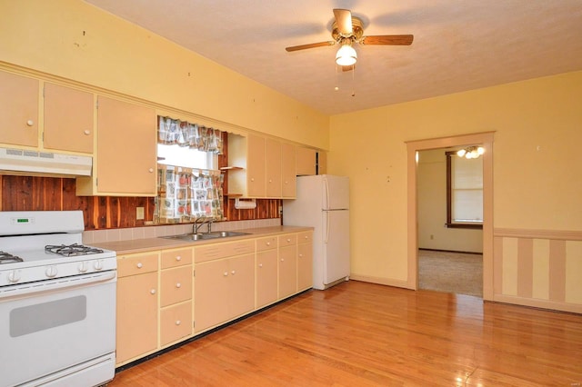 kitchen with ceiling fan, white appliances, sink, and light wood-type flooring