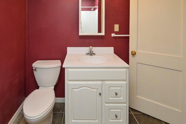 bathroom with vanity, tile patterned floors, and toilet