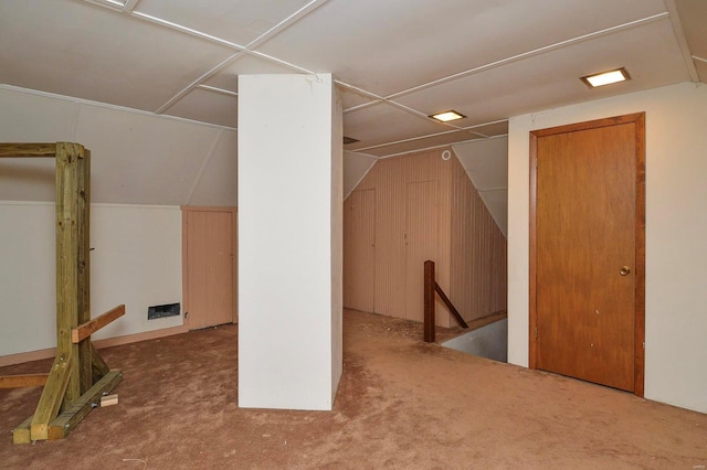 additional living space featuring lofted ceiling and carpet floors