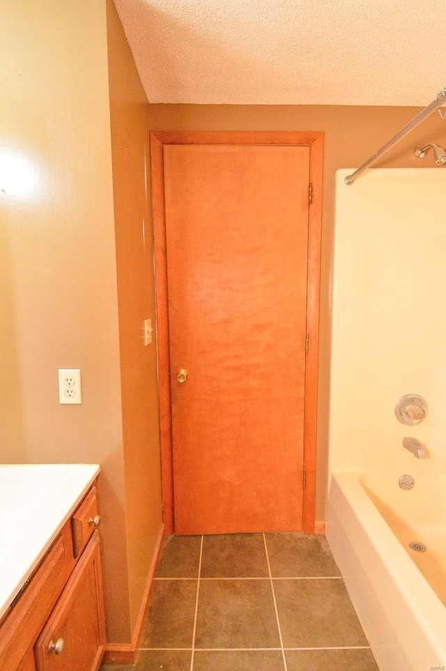 bathroom with vanity, tile patterned floors, and a textured ceiling