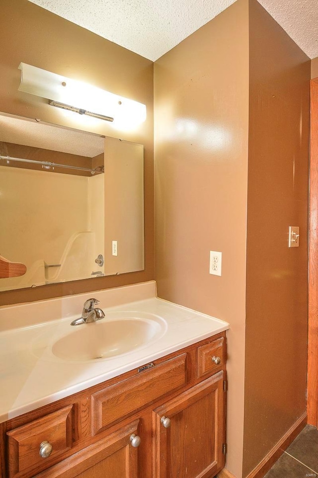 bathroom with vanity, tile patterned floors, and a textured ceiling