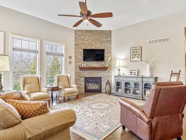 living room with light hardwood / wood-style flooring, a fireplace, and ceiling fan