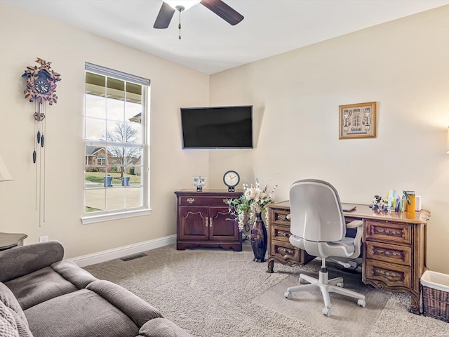 carpeted home office featuring ceiling fan