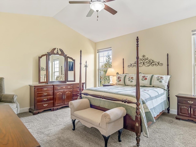 bedroom with ceiling fan, light colored carpet, and lofted ceiling