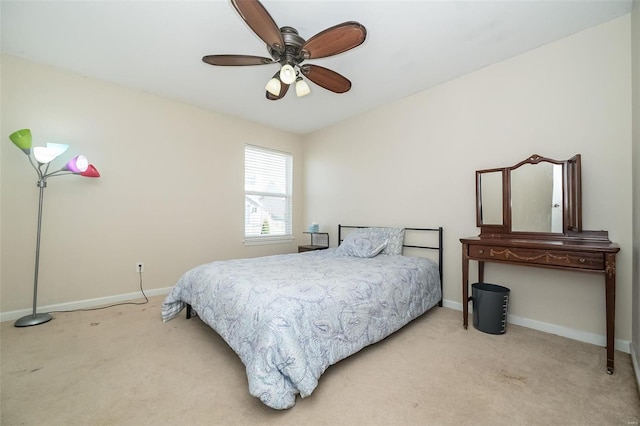 bedroom with light carpet, ceiling fan, and baseboards