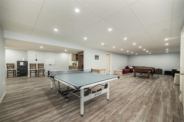 game room featuring a drop ceiling, wood finished floors, and recessed lighting