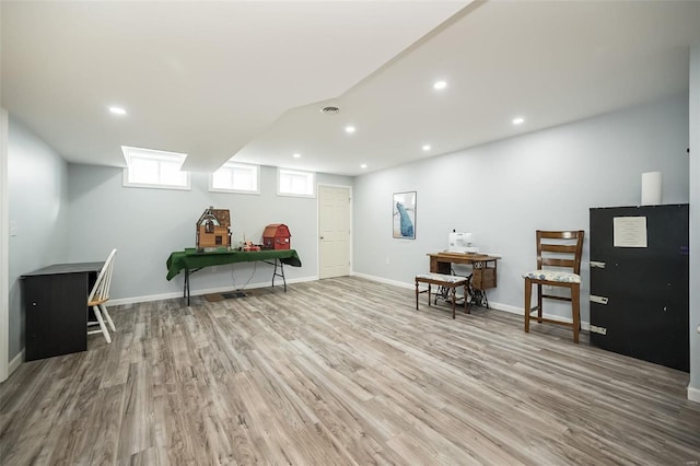 interior space with light wood finished floors, baseboards, and recessed lighting