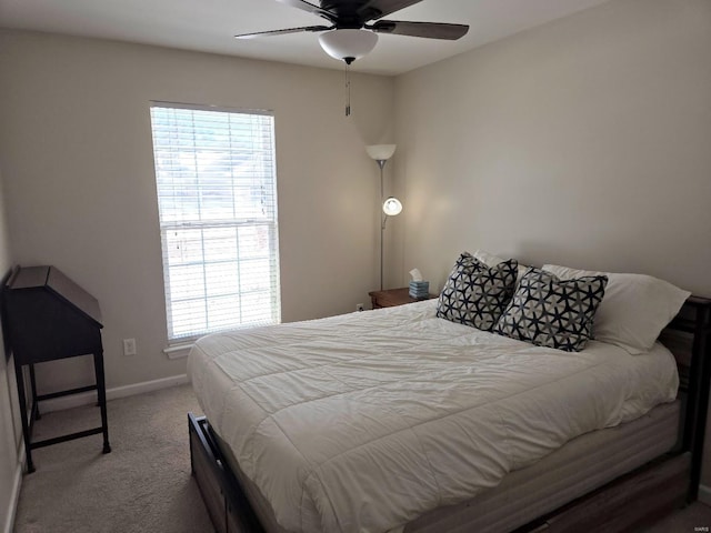 carpeted bedroom with a ceiling fan and baseboards