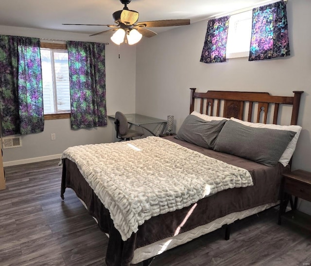 bedroom featuring ceiling fan, dark wood-style flooring, visible vents, and baseboards