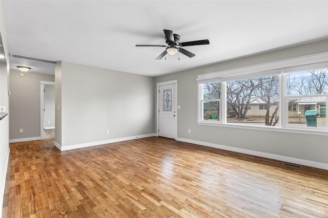 spare room with ceiling fan and light wood-type flooring