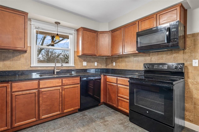 kitchen featuring sink, decorative light fixtures, black appliances, dark stone counters, and backsplash