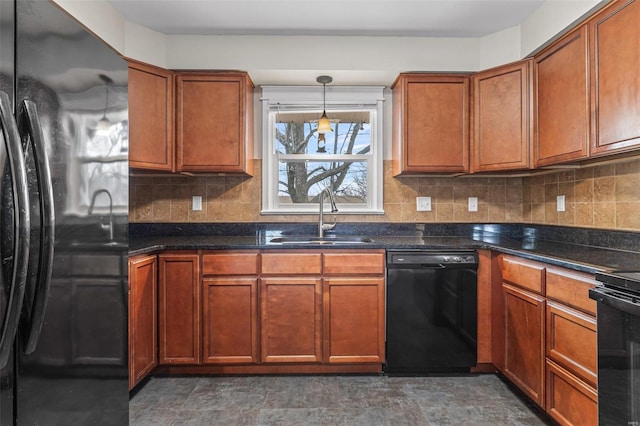 kitchen with sink, dark stone countertops, backsplash, black appliances, and decorative light fixtures