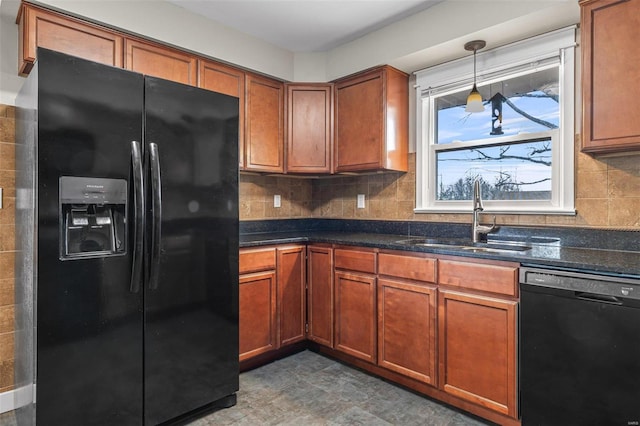 kitchen with sink, black appliances, hanging light fixtures, dark stone countertops, and backsplash