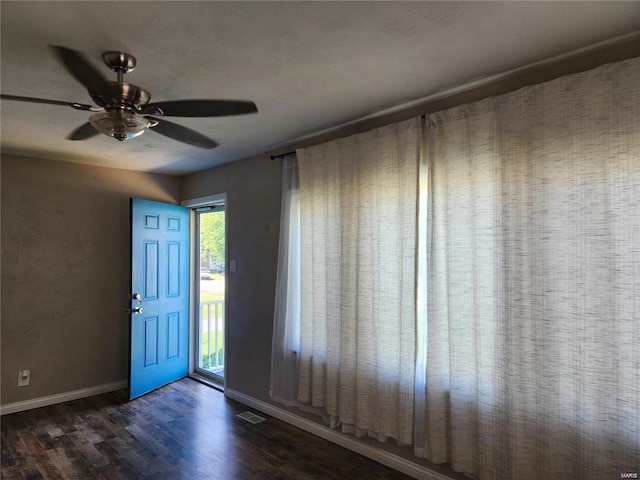 foyer entrance featuring ceiling fan and dark hardwood / wood-style floors