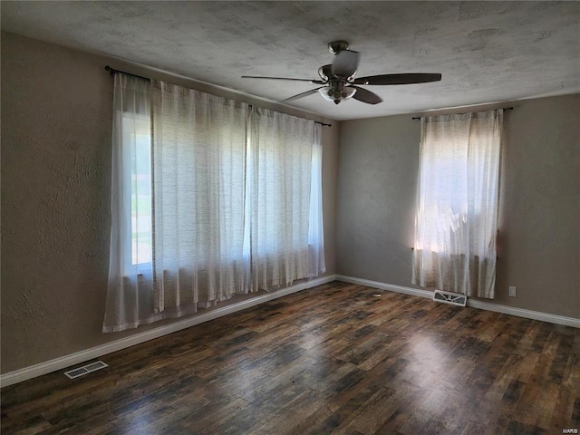 unfurnished room featuring ceiling fan and dark hardwood / wood-style flooring