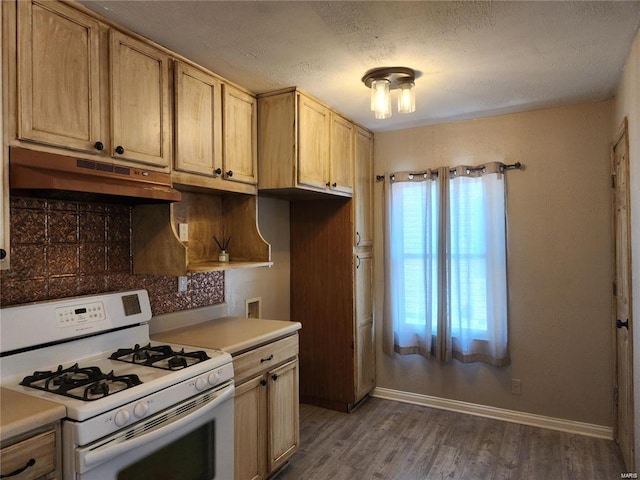 kitchen with tasteful backsplash, a textured ceiling, dark hardwood / wood-style flooring, white gas range, and light brown cabinets