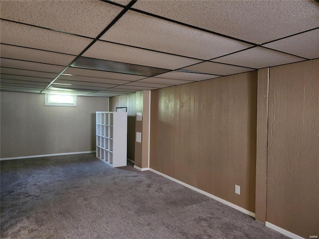 basement featuring carpet floors and a paneled ceiling