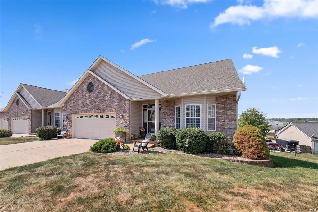 view of front of property with a garage and a front lawn