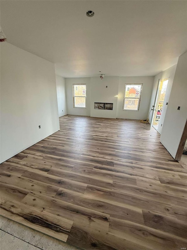 unfurnished living room featuring hardwood / wood-style flooring