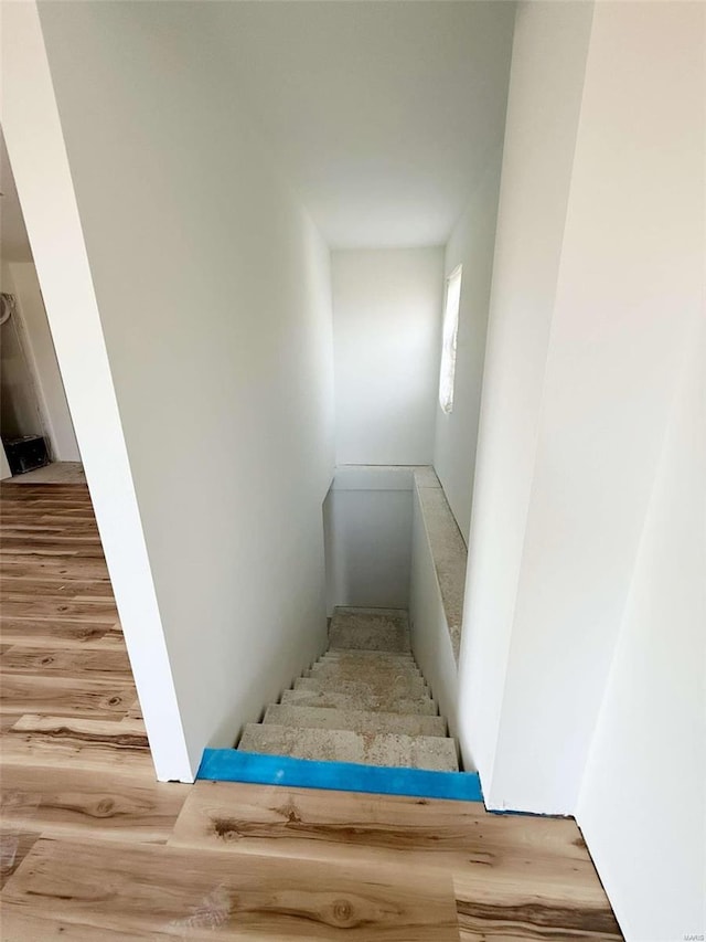 stairs featuring hardwood / wood-style floors