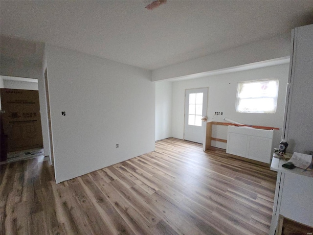 unfurnished living room with wood-type flooring