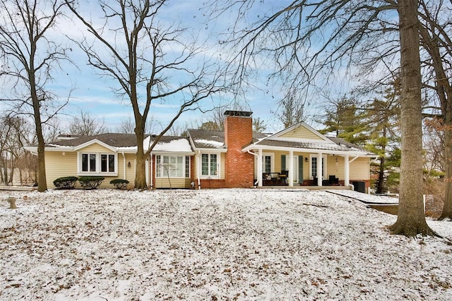 snow covered property featuring a porch