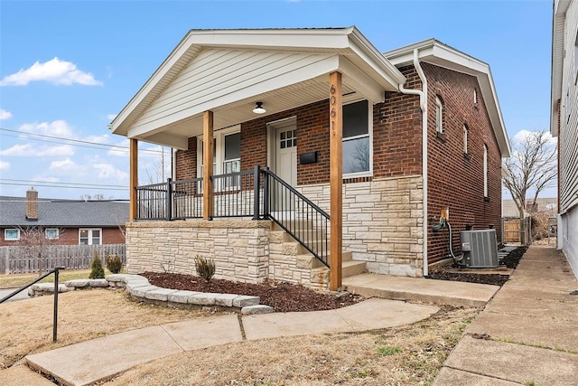 view of front of home featuring central air condition unit and a porch