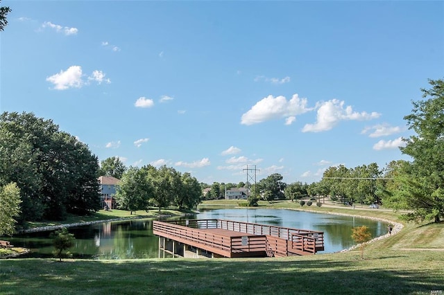 dock area with a water view and a yard