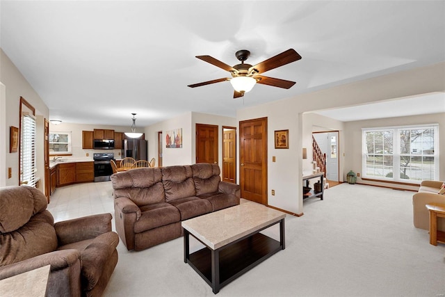 carpeted living room featuring ceiling fan